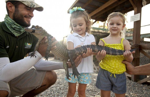 Children with a baby alligator