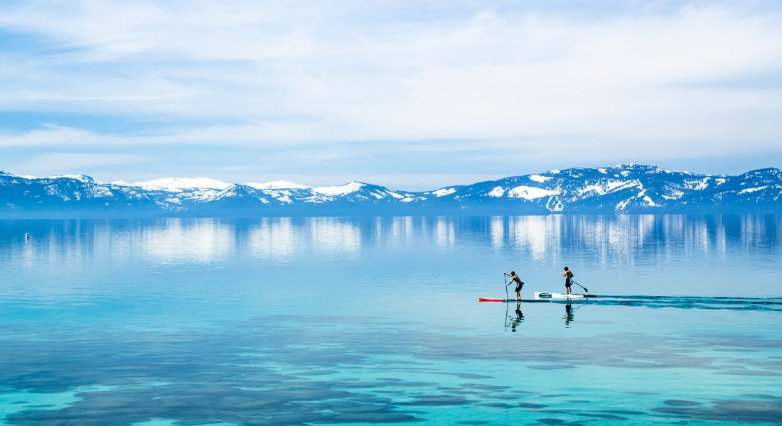 Two people on stand up paddleboards on Lake Tahoe in California